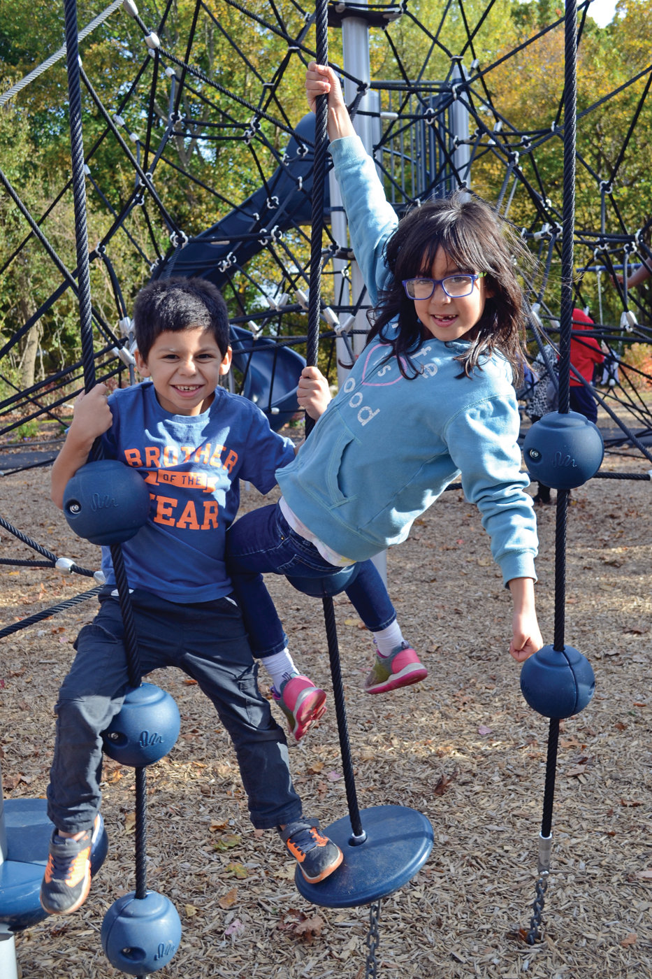 WHAT IT'S ALL ABOUT: Nicholas and Lillian St. Germain tested out part of the new playground shortly after the ribbon was cut, and the smiles seemed to indicate a positive review.